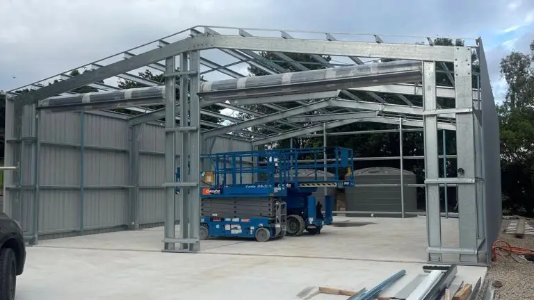 Shed frame going up with steel components on slab at caravan and boat storage shed site.