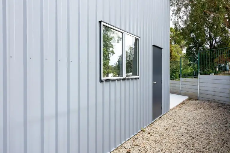 Close-up of COLORBOND® Bluegum cladding with window and personal access door on a caravan and boat storage shed.