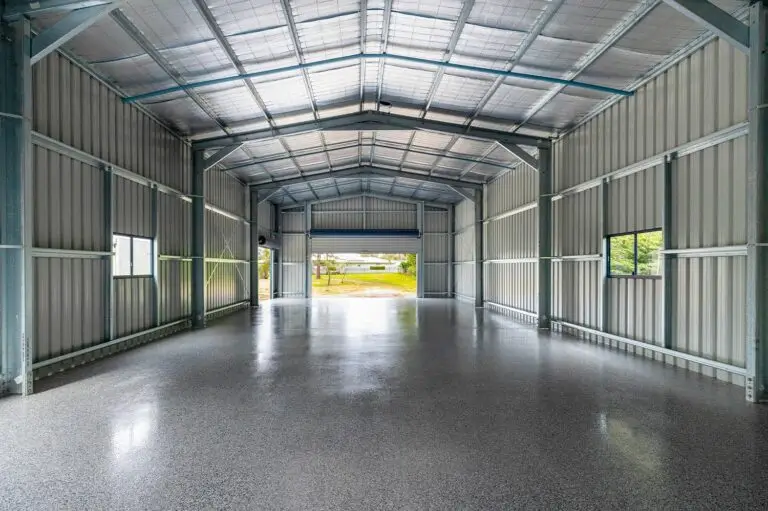 Interior of workshop shed in Forestdale showing epoxy floor and drive-through roller doors